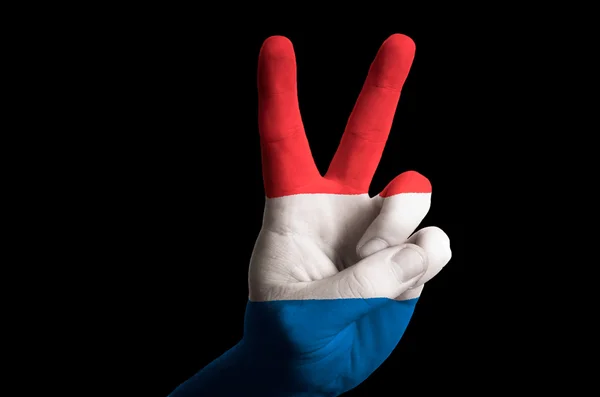 Niederländische Nationalflagge zwei Finger hoch Geste für den Sieg und — Stockfoto