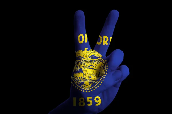 Oregon us state flag two finger up gesture for victory and winne — Stock Photo, Image