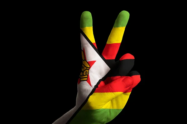 Zimbabwe national flag two finger up gesture for victory and win — Stock Photo, Image