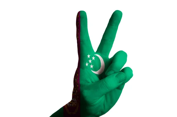Національний прапор Туркменістану два пальці вгору жестом для перемоги і — стокове фото