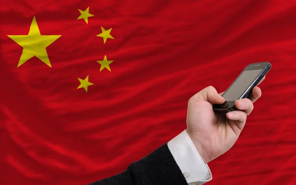 Cell phone in front national flag of china — Stock Photo, Image