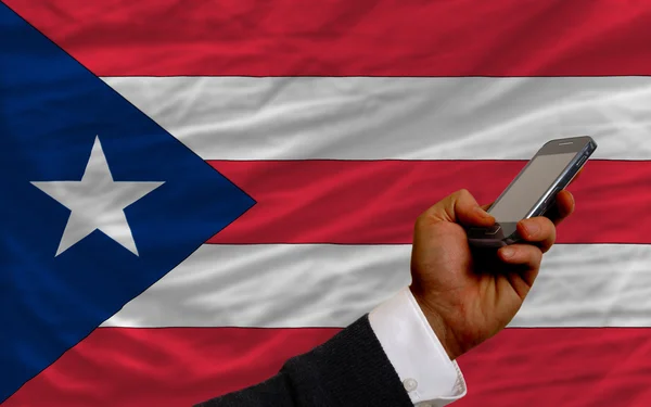Cell phone in front national flag of puertorico — Stock Photo, Image