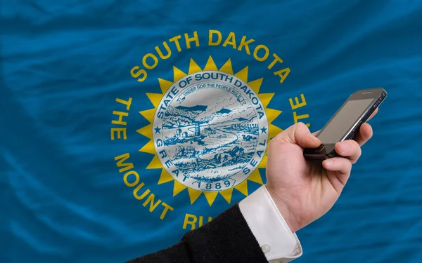 Cell phone in front flag of american state of south dakota — Stock Photo, Image