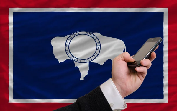 Cell phone in front flag of american state of wyoming — Stock Photo, Image