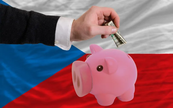 Dollar into piggy rich bank and national flag of czech — Zdjęcie stockowe