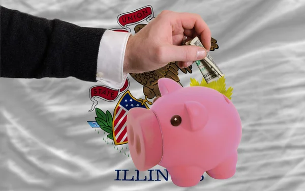Dólar em porquinho rico banco e bandeira do estado americano de illin — Fotografia de Stock