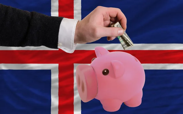 Dollar till rika piggy bank och nationella flagga Island — Stockfoto