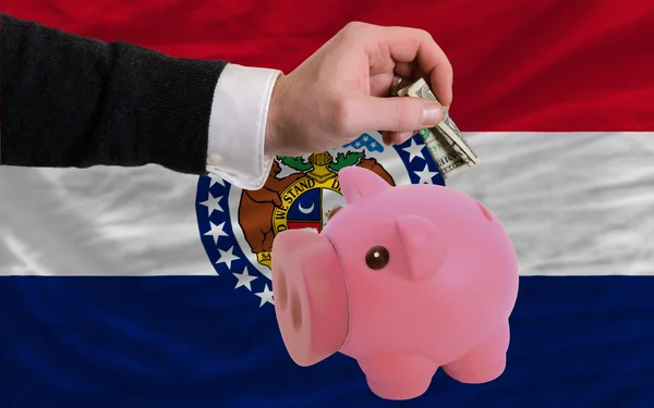 Dollar in piggy rijke bank en vlag van Amerikaanse staat van misso — Stockfoto