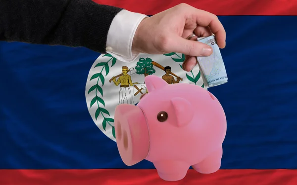 Funding euro into piggy rich bank national flag of belize — Stock Photo, Image