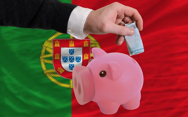 Funding euro into piggy rich bank national flag of portugal — Stock Photo, Image