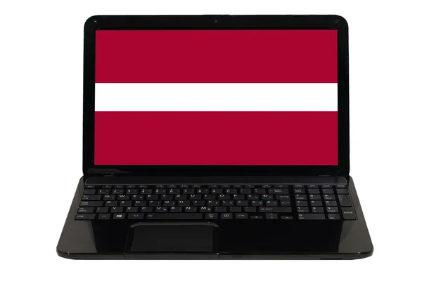 ラトビアの国旗を持つラップトップ コンピューター — ストック写真