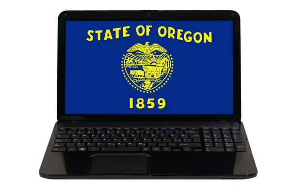 Laptop-computer mit flagge des amerikanischen staates oregon — Stockfoto