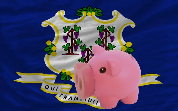 Piggy rich bank and flag of american state of connecticut — Stock Photo, Image