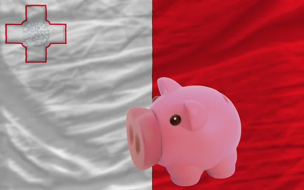 Piggy rich bank and national flag of malta — Stock Photo, Image