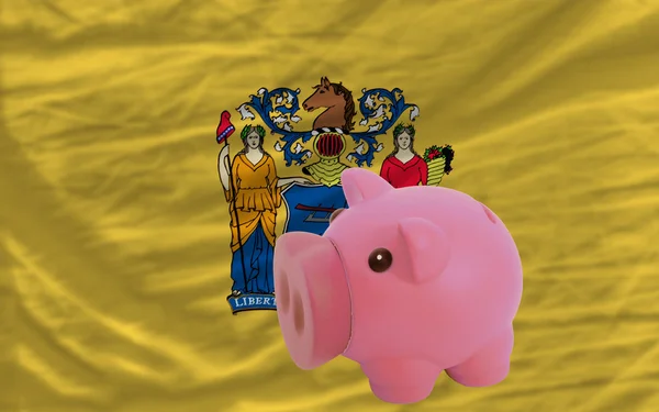 Piggy rich bank and flag of american state of new jersey — Stock Photo, Image