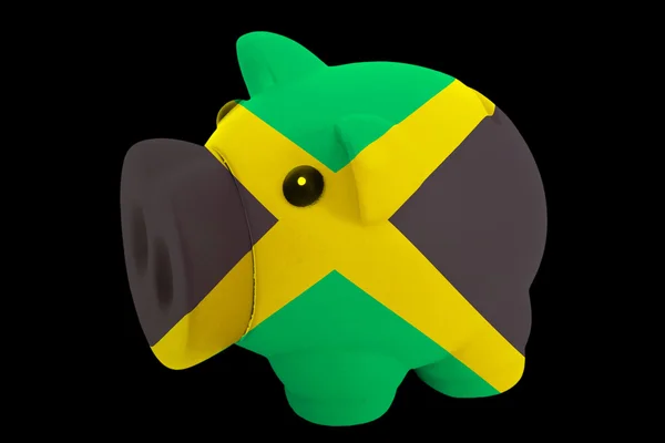 Rika piggy bank i färger nationella flagga jamaica för att spara — Stockfoto