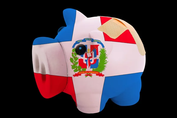 Bankrupt piggy rich bank in colors of national flag of dominican — Stock Photo, Image