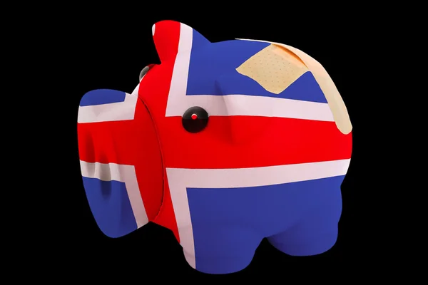 Failliete piggy rijke bank in de kleuren van de nationale vlag van IJsland — Stockfoto