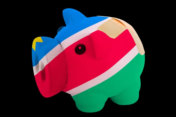 Bankrupt piggy rich bank in colors of national flag of namibia — Stock Photo, Image