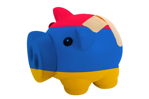 Closed piggy rich bank with bandage in colors national flag of a — Stock Photo, Image