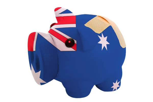 Closed piggy rich bank with bandage in colors national flag of a — Stock Photo, Image