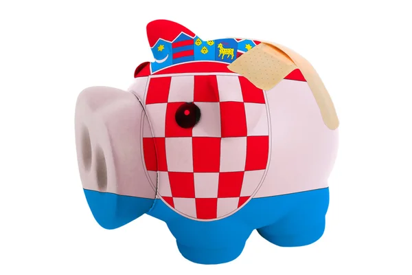 Closed piggy rich bank with bandage in colors national flag of c — Stock Photo, Image