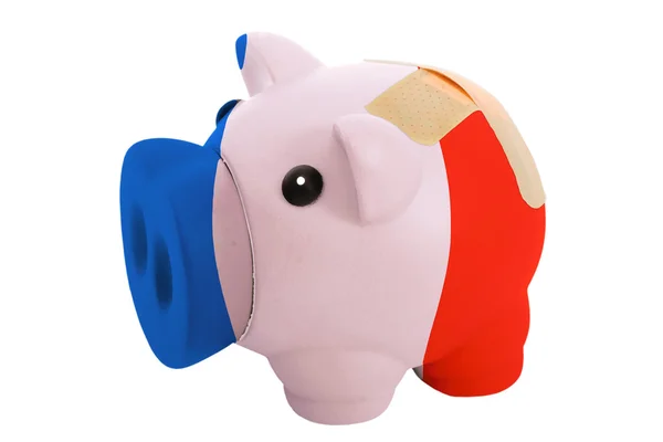 Closed piggy rich bank with bandage in colors national flag of f — Stock Photo, Image