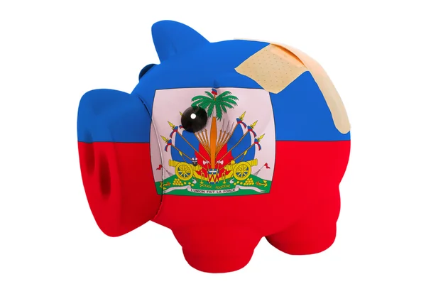 Closed piggy rich bank with bandage in colors national flag of h — Stock Photo, Image