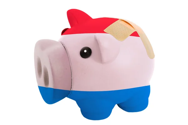 Closed piggy rich bank with bandage in colors national flag of h — Stock Photo, Image