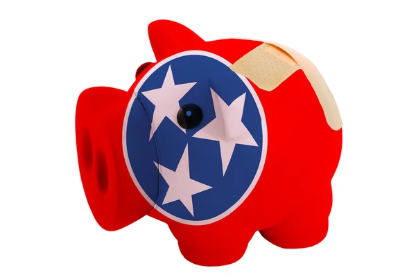 Closed piggy rich bank with bandage in colors flag of american s — Stock Photo, Image