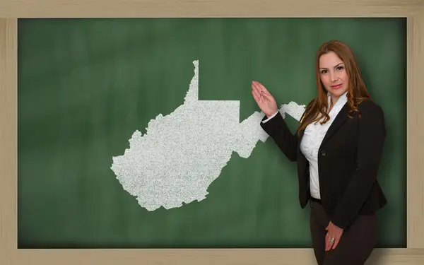 Teacher showing map of west virginia on blackboard — Stock Photo, Image