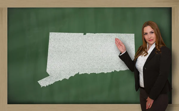 Teacher showing map of connecticut on blackboard — Stock Photo, Image