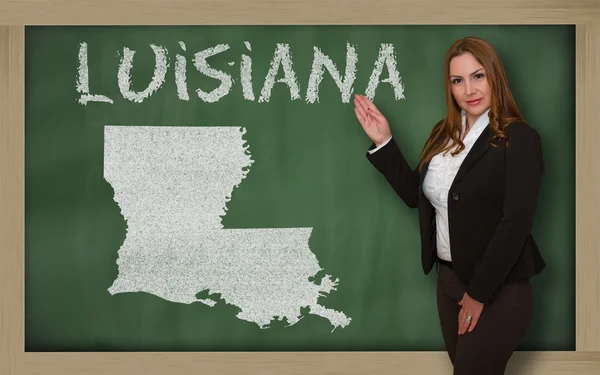 Teacher showing map of luisiana on blackboard — Stock Photo, Image