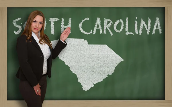 Teacher showing map of south carolina on blackboard — Stock Photo, Image