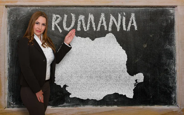 Teacher showing map of romania on blackboard — Stock Photo, Image