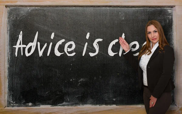 Teacher showing Advice is cheap on blackboard — Stock Photo, Image