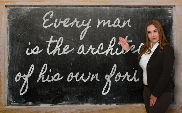 Teacher showing Every man is the architect of his own fortune on — Stock Photo, Image