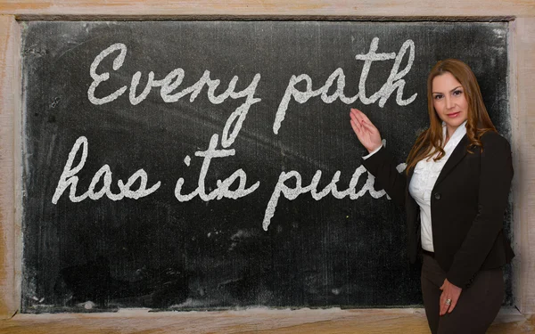 Teacher showing Every path has its puddle on blackboard — Stock Photo, Image