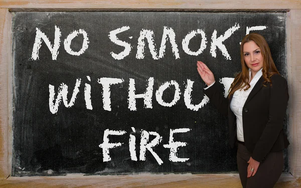 Teacher showing No smoke without fire on blackboard — Stock Photo, Image