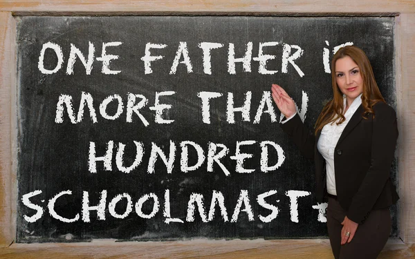 Teacher showing One father is more than a hundred schoolmasters — Stockfoto