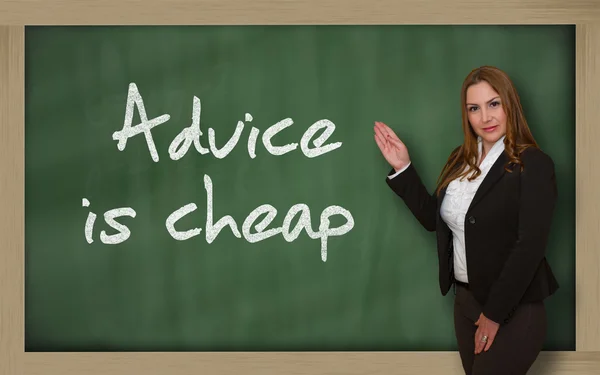 Teacher showing Advice is cheap on blackboard — Stock Photo, Image