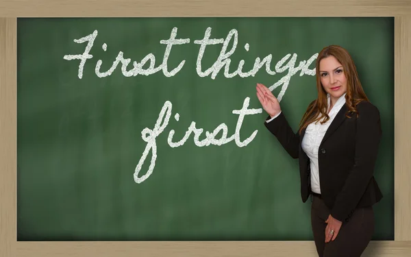 Δάσκαλος δείχνει πρώτα πράγματα πρώτο στο blackboard — Φωτογραφία Αρχείου
