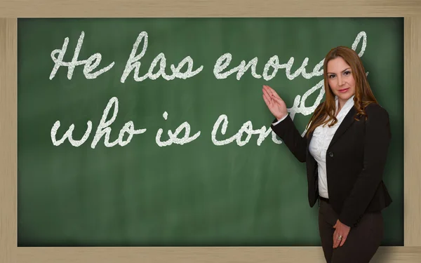 Teacher showing He has enough who is content on blackboard — Stock Photo, Image