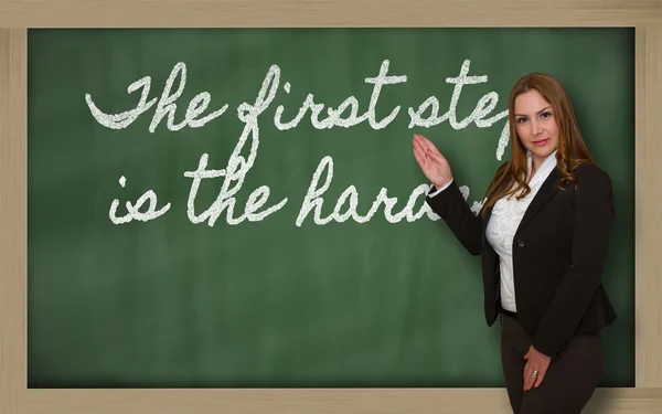 Teacher showing The first step is the hardest on blackboard — Stock Photo, Image