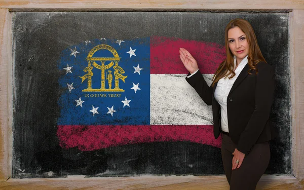 Teacher showing flag ofGeorgia on blackboard for presentation ma — Stock Photo, Image