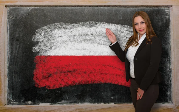 Teacher showing flag ofPoland on blackboard for presentation mar — Stock Photo, Image