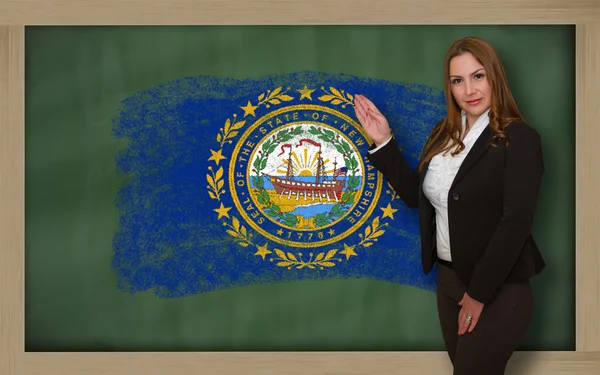 Lehrerin zeigt Flagge der neuen Grafschaft Hampshire auf Tafel zur Präsentation — Stockfoto