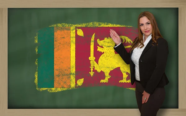 Lehrer zeigt Fahne von fsrilanka auf Tafel zur Präsentation m — Stockfoto