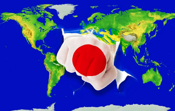 Faust in Farbe Nationalflagge Japans beim Stanzen der Weltkarte — Stockfoto