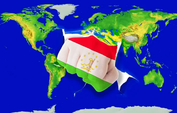 Faust in Farbe Nationalflagge Tadschikistans beim Stanzen der Weltkarte — Stockfoto